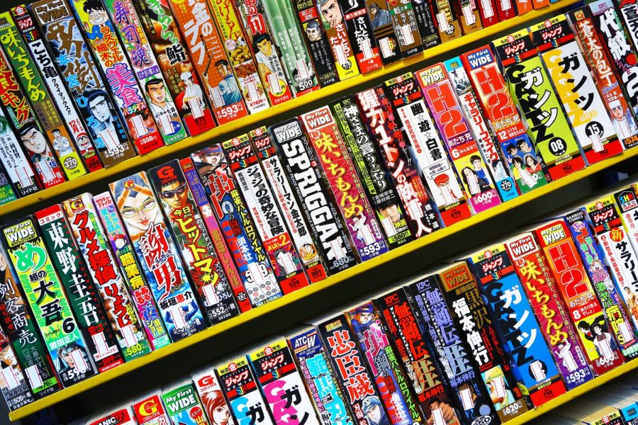 A photo of a book shelf containing three rows of manga comics.