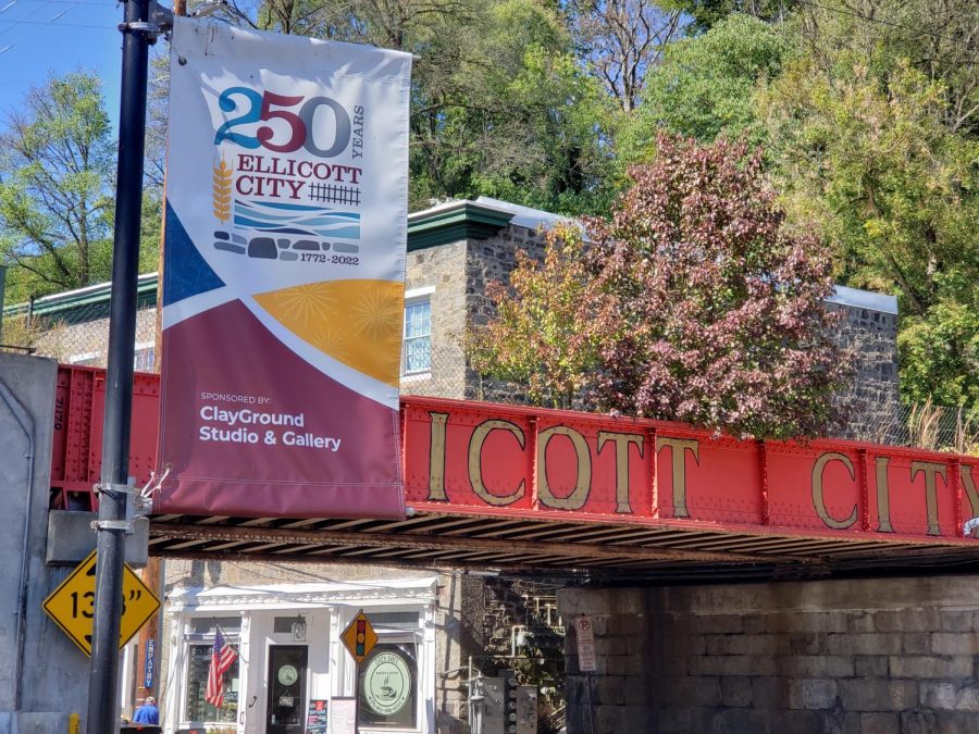 A banner celebrating the Ellicott City Sestercentennial, located in front of the railroad bridge into the town.