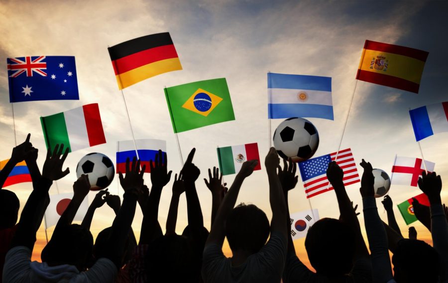 FIFA+Football+fans+gathering+and+holding+their+countries+team+flags+