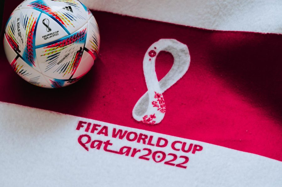QATAR, DOHA, 18 JULY, 2022: Official Adidas World Cup Football Ball Al Rihla. And logo of FIFA World Cup in Qatar 2022 on red carpet. Soccer sport background.