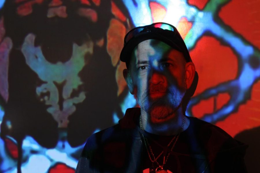 Patrick Pagano, with the featured image of his PICTOMANCY exhibit projected onto him
