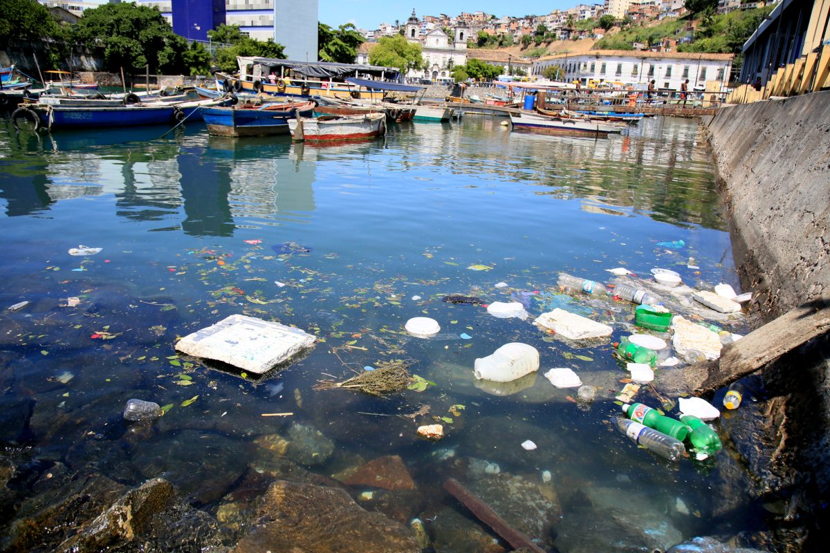 Salvador, Bahia, Brazil - December 11, 2020: Disposal of plastic packaging and garbage at sea near the port of boats at Feira de Sao Joaquim, in the city of Salvador.