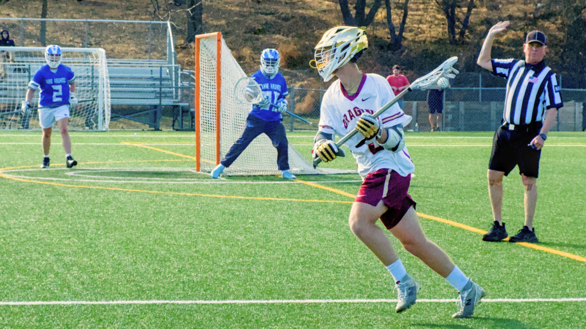 HCC's men's lacrosse team playing during game.
