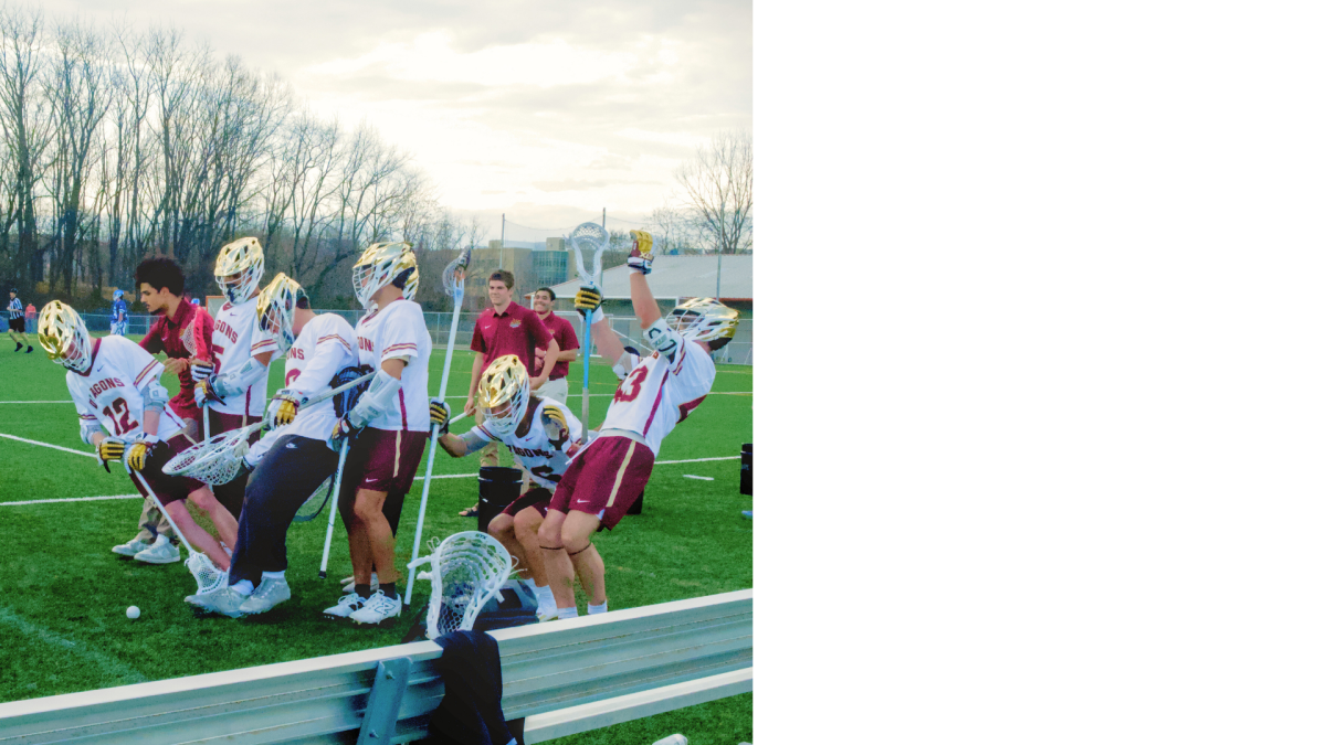 HCC's men's lacrosse team playing during game.